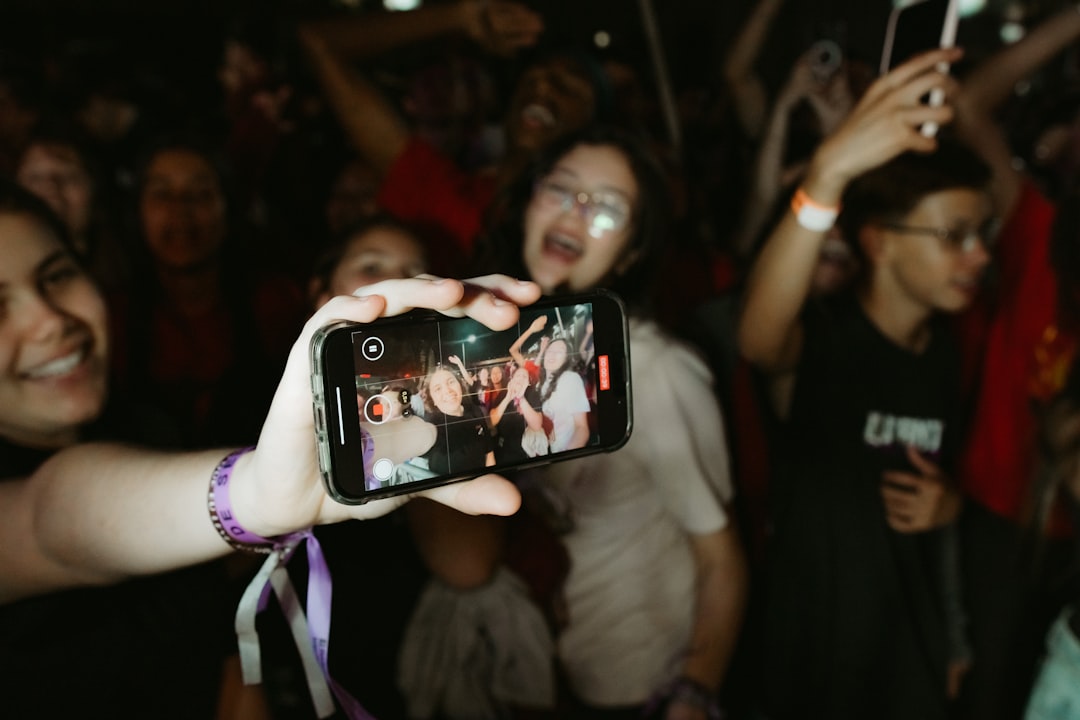A person coding on a laptop in a creative workspace.
